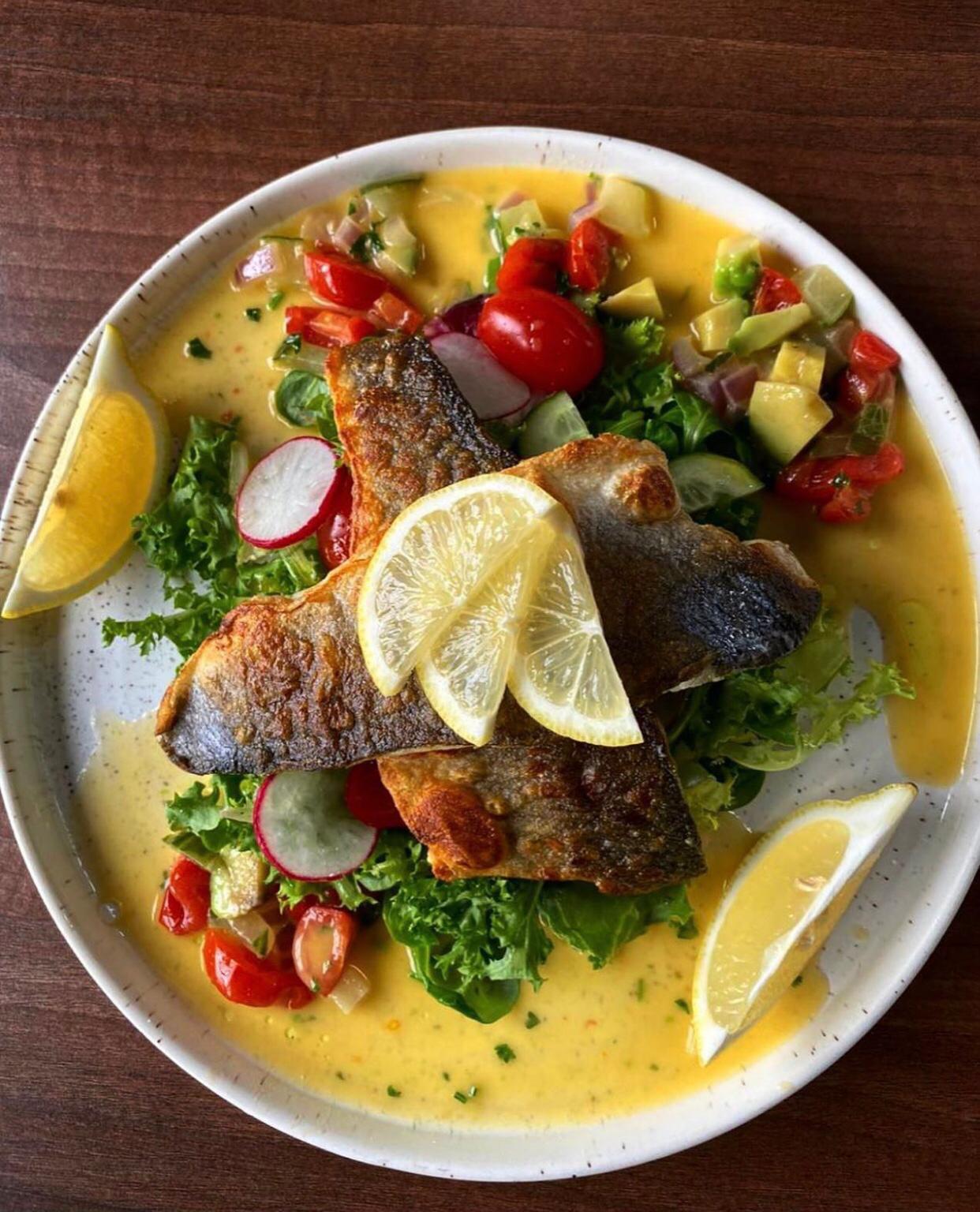 Pan-fried sea bass with salad and a citrus dressing